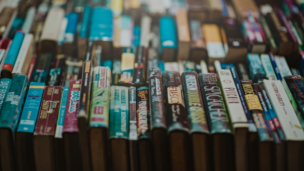 books laid out on a table spine side up