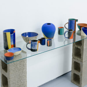 A collection of colorful pottery arrayed on a table.