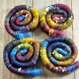 Textile art of 2oz hand-dyed, rolled wool.