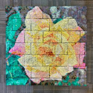 A textile mosaic that looks like a yellow flower.