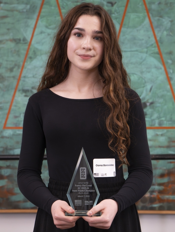 Oona Borovicka, a young white female, poses with her trophy